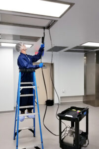 technician testing cleanroom air pressure