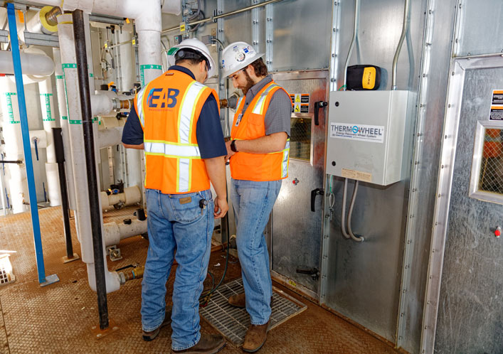 two healthcare commissioning engineers checking the hvac system of a building in Houston